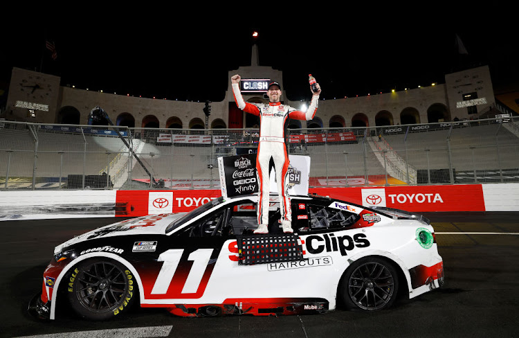 Denny Hamlin celebrates in victory lane after winning the NASCAR Cup Series Busch Light Clash at The Coliseum at Los Angeles Memorial Coliseum on February 3, 2024 in Los Angeles, California.