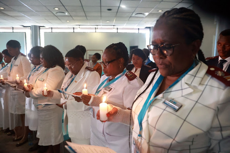 Nurses hold candles in honour of nurses who died during the Covid-19 pandemic at at the Nursing Council offices in Pretoria in this file photo. Picture: VELI NHLAPO