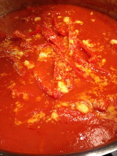 Red peppers in a tomato sauce sprinkled with Parmesan cheese.