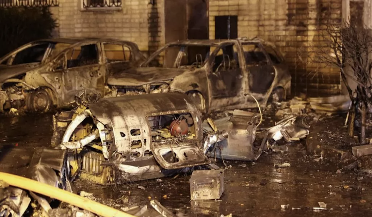 Debris from the plane littered a courtyard by the gutted apartment block