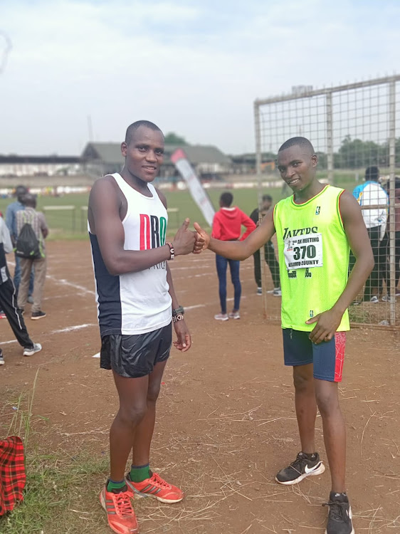 Dominic Samson Ndigiti pose for a photo with his colleague after winning 10,000m race walk in Kisumu