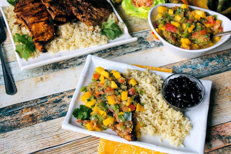 Mango Salsa, Black Beans, Chicken And Rice On A Plate.