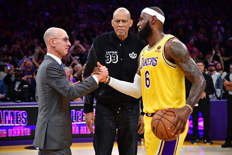 LA Lakers forward LeBron James meets with former player Kareem Abdul-Jabbar and NBA commissioner Adam Silver after breaking the NBA all time scoring record against the Oklahoma City Thunder during the second half at Crypto.com Arena in Los Angeles, California on February 7 2023.