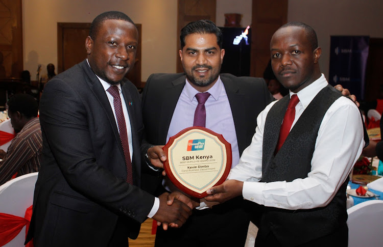 Unionpay's Maurice Nyakundi, Sahil Arya and Kevin Dimba pose with Dimba's Best Employee Award 2019