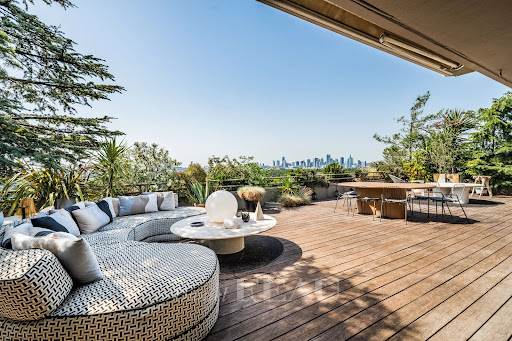 Apartment / penthouse purchase in Paris 16ème (75016) - Wooden terrace with outdoor furniture and city view