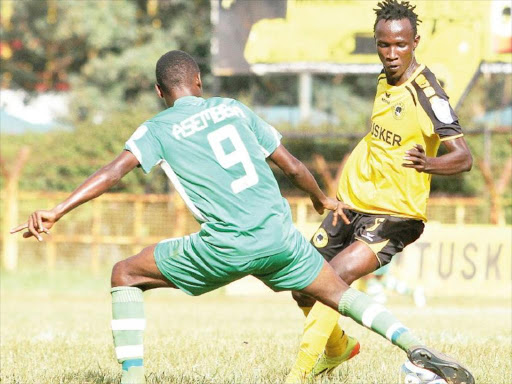 Tusker’s Shafik Batambuze side steps away from Sony Sugar’s Amos Asembeka tackle. /ENOS TECHE