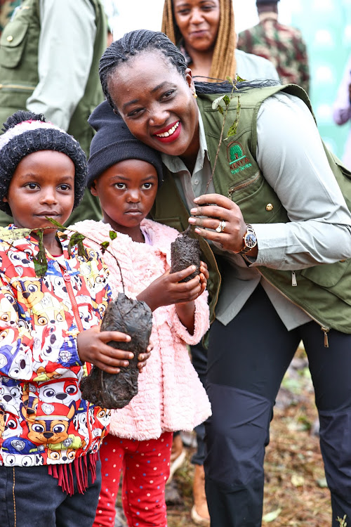 Environment CS Soipan Tuya interacts with children during the national tree planting day at Kiambicho Forest Karua Hill A, Murang'a County, on May 10, 2024.