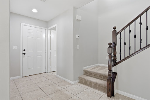 entrance hall with staircase and white door - House purchase in Henderson, 3 bedrooms